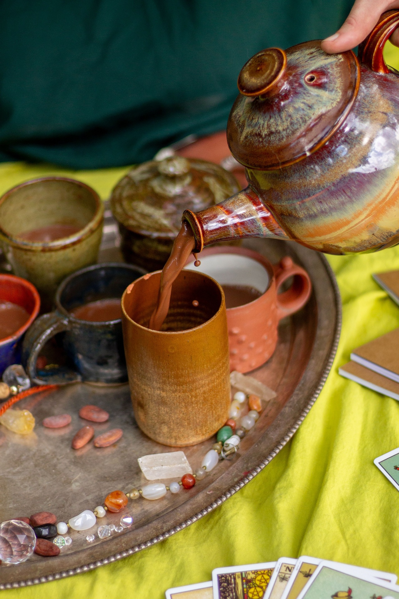 Ceremonial cacao poured with crystals and oracle cards