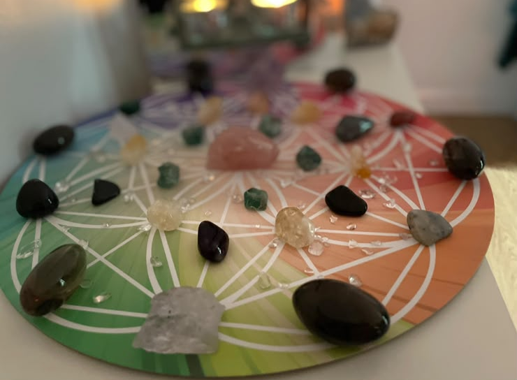 Flower of Life crystal grid on a chakra colour wheel